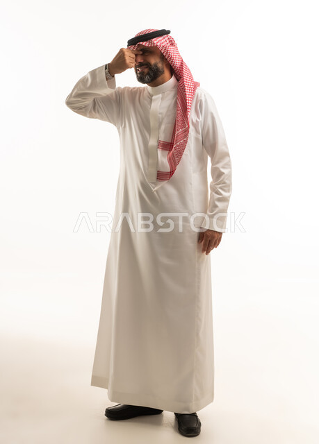 Saudi Man in Traditional Thobe with Headache Studio Shot