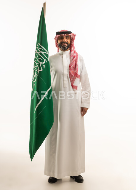 Saudi Man Holding National Flag in Studio
