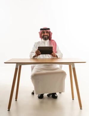 Saudi Man with Tablet at Office Desk White Background