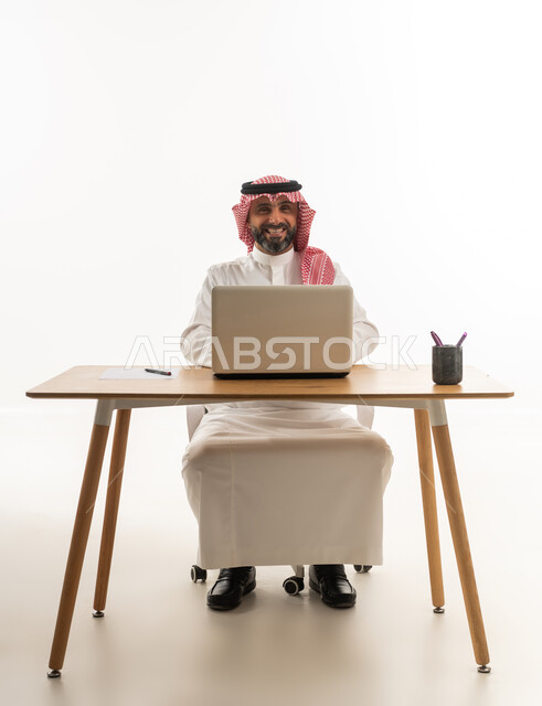 Saudi Businessman with Laptop at Office Desk