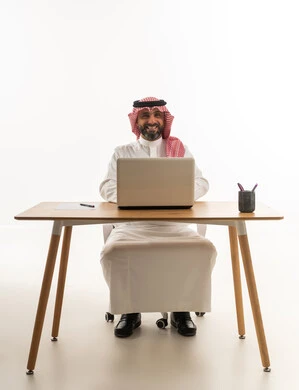 Saudi Businessman with Laptop at Office Desk