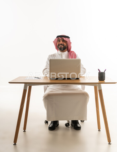 Saudi Businessman with Laptop at Desk