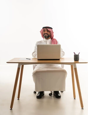 Saudi Businessman with Laptop at Desk
