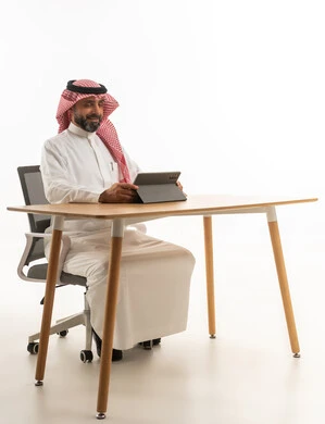 Saudi Businessman with Tablet at Desk White Background