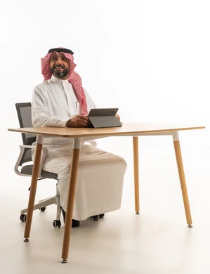 Saudi Businessman with Tablet at Office Desk