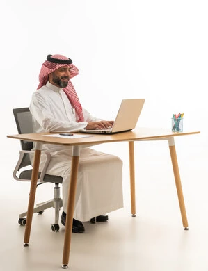 Saudi Businessman Working on Laptop at Office Desk