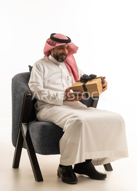 Saudi Man in Traditional Thobe Holding Gift Box