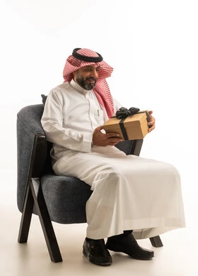 Saudi Man in Traditional Thobe Holding Gift Box