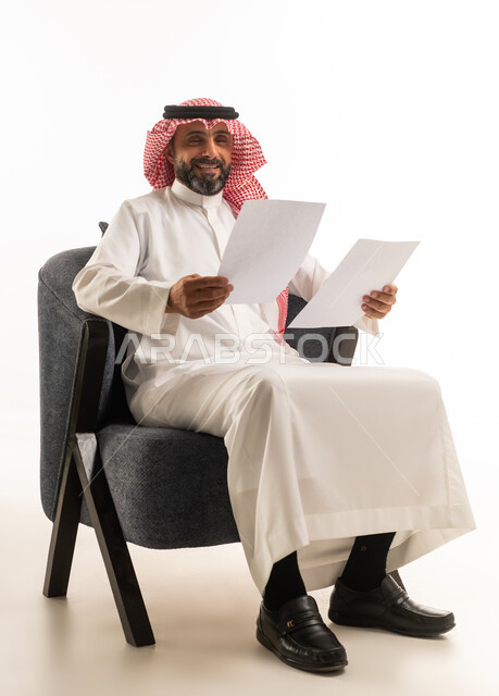 Saudi Businessman Sitting With Documents on White Background