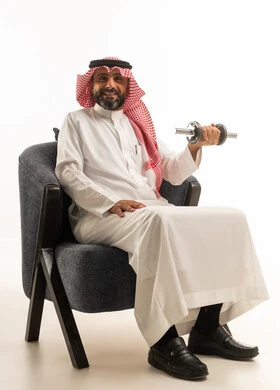 Saudi Man in Traditional Thobe Lifting Weights