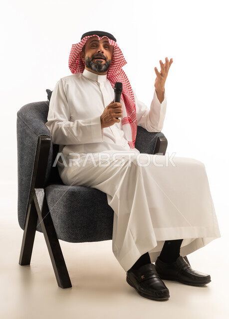 Saudi Man in Traditional Dress Speaking with Microphone