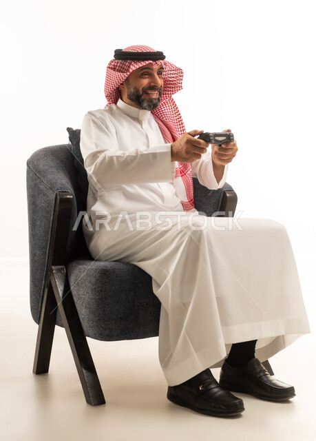 Saudi Man in Traditional Thobe Playing Video Games