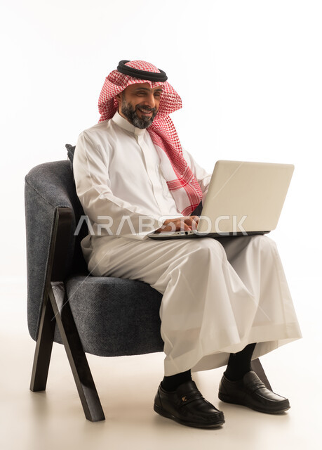 Saudi Businessman Using Laptop in Traditional Thobe