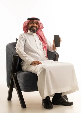 Saudi Man in Traditional Thobe Holding Smartphone