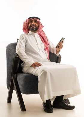Saudi Man in Traditional Dress with Smartphone