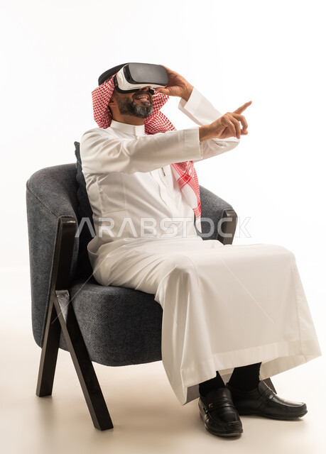 Saudi Man Using Virtual Reality Headset on White Background