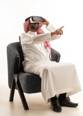 Saudi Man Using Virtual Reality Headset on White Background