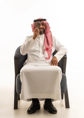 Saudi Man Holding Magnifying Glass on White Background