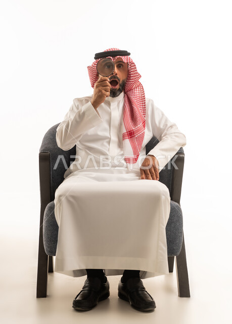 Saudi Man with Magnifying Glass Surprised Expression
