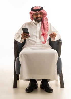 Saudi Man Using Credit Card and Smartphone on White Background