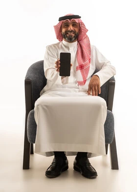 Saudi Man in Traditional Thobe Holding Smartphone