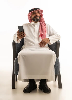 Saudi Man in Traditional Thobe Holding Smartphone