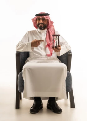 Saudi Man Holding Hourglass on White Background