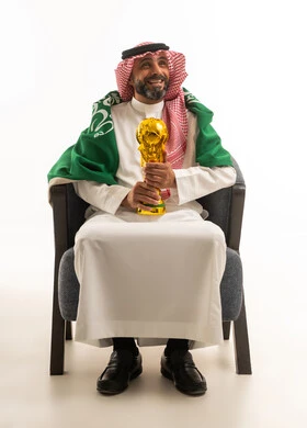 Saudi Man Holding Football Trophy with National Flag