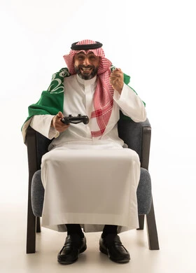 Saudi Man Gaming with Controller and National Flag