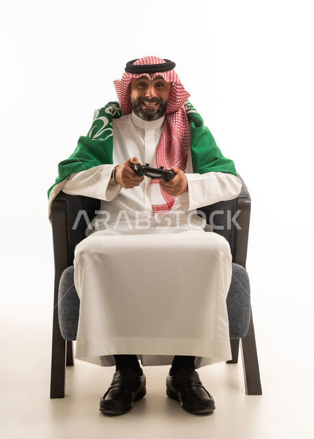 Saudi Man Gaming with National Flag in Studio