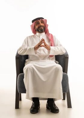 Saudi Man in Traditional Thobe Sitting on Armchair