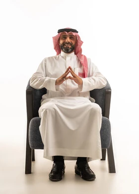 Saudi Businessman in Traditional Thobe Sitting on Armchair