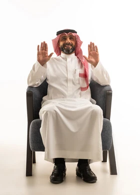 Saudi Man in Traditional Dress Sitting in Armchair