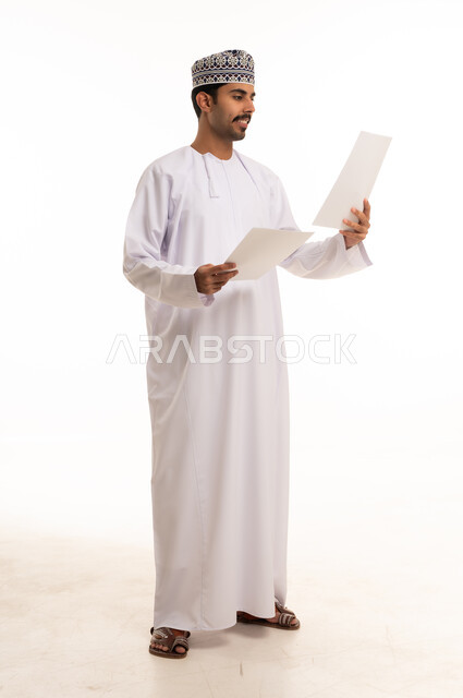 Omani Man in Traditional Dishdasha Holding Papers
