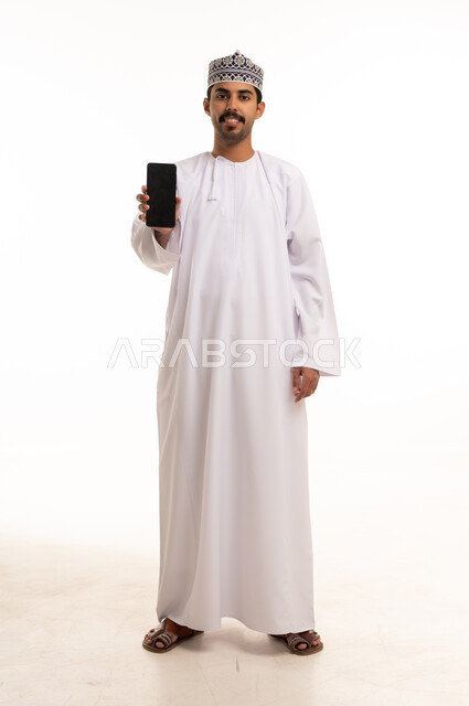 Omani Man Holding Blank Smartphone Screen in Studio