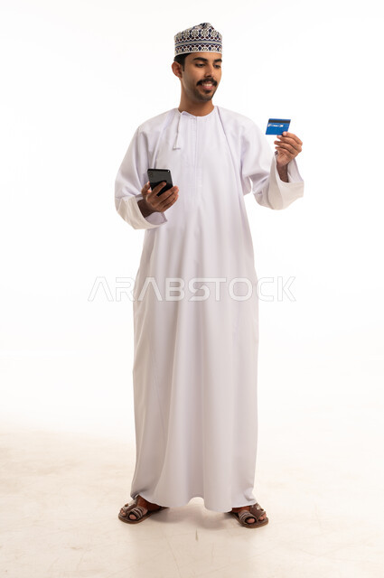 Omani Man with Smartphone and Credit Card Studio Shot