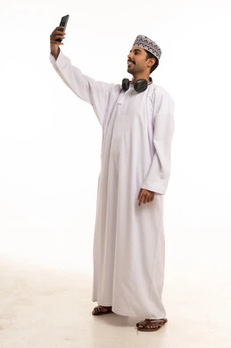 Omani Man Taking Selfie with Smartphone in Studio