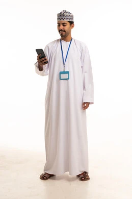 Omani Man in Traditional Dress Using Smartphone