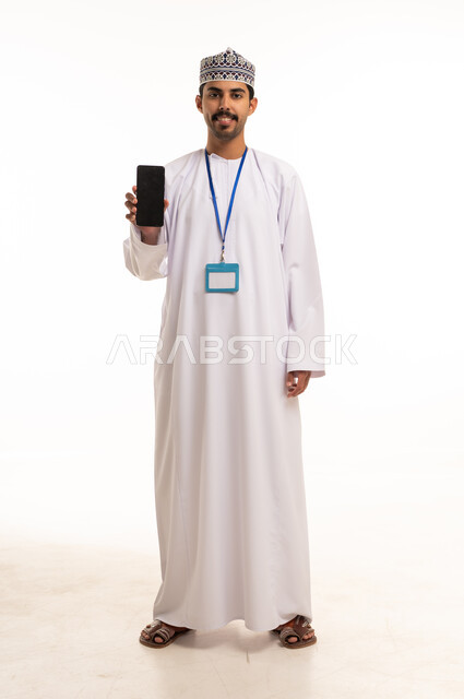 Omani Man Holding Smartphone with ID Badge Studio