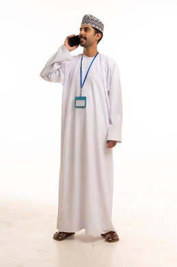 Omani Man in Traditional Dress Talking on Smartphone