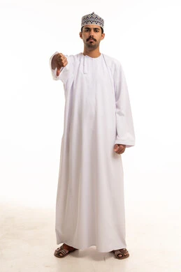 Omani Man Gesturing Thumbs Down in Traditional Dress