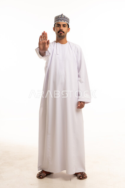 Omani Man in Traditional Dishdasha Making Stop Gesture