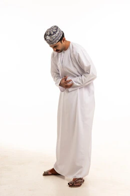 Omani Man in Traditional Dishdasha with Stomach Ache