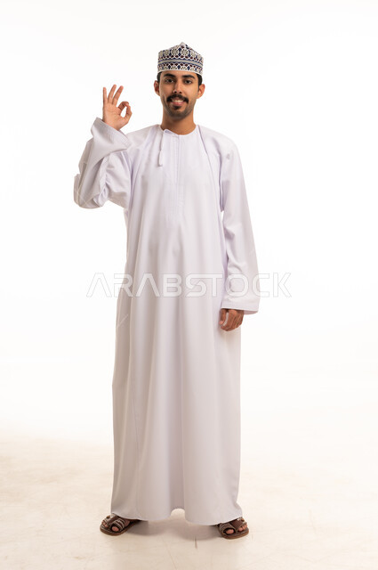 Omani Man in Traditional Dishdasha Making Okay Hand Sign