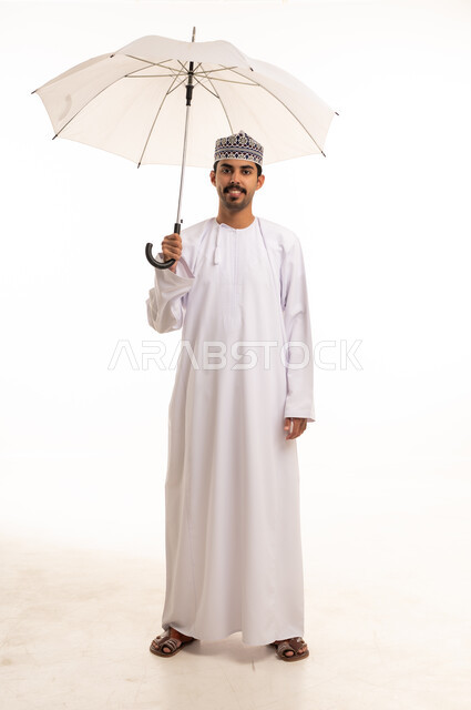Omani Man in Traditional Dishdasha Holding White Umbrella
