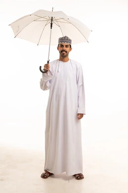 Omani Man in Traditional Dishdasha Holding White Umbrella