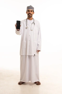 Omani Male Doctor Holding Smartphone in White Studio