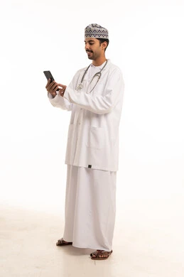 Omani Doctor Using Smartphone in Lab Coat
