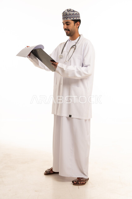 Omani Doctor in Lab Coat Holding Medical Clipboard