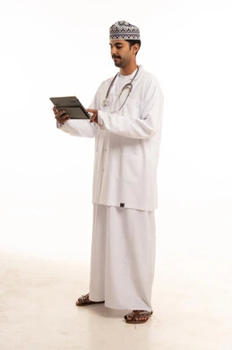 طبيب عماني يستخدم الجهاز اللوحي بخلفية بيضاء